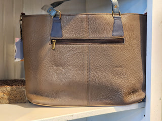 Brown leather handbag with blue accents on a white surface